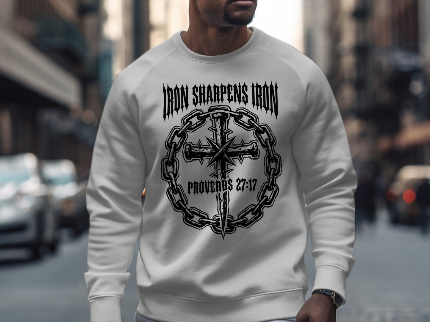 White sweatshirt with "Iron Sharpens Iron" and cross logo.