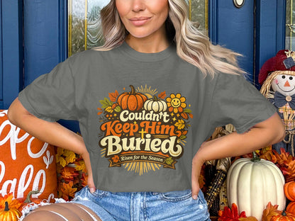 Gray t-shirt with pumpkins, leaves, and "Couldn't Keep Him Buried Risen for the Season" text.