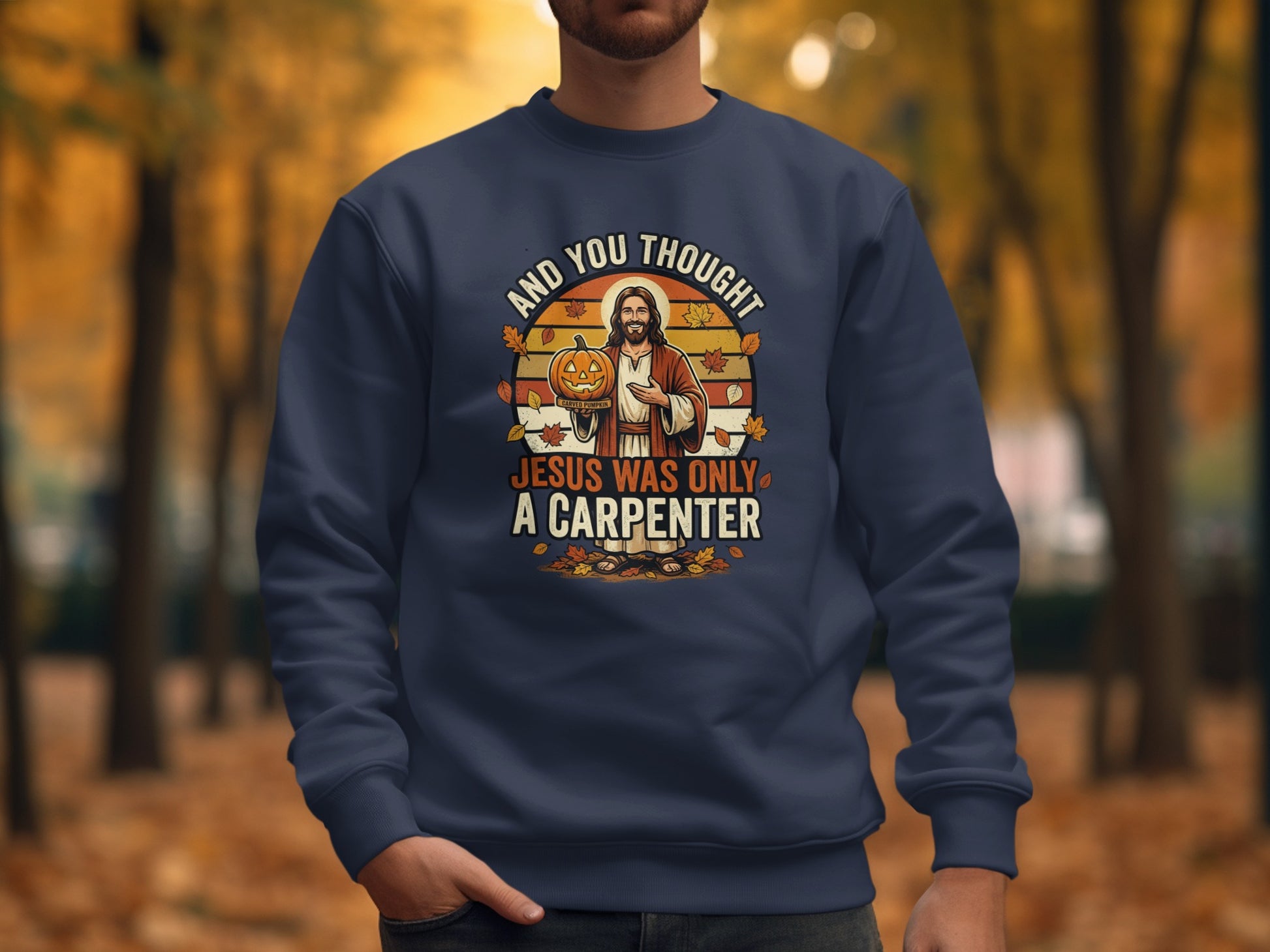 Navy sweatshirt with Jesus holding a pumpkin, text "And You Thought Jesus Was Only a Carpenter."