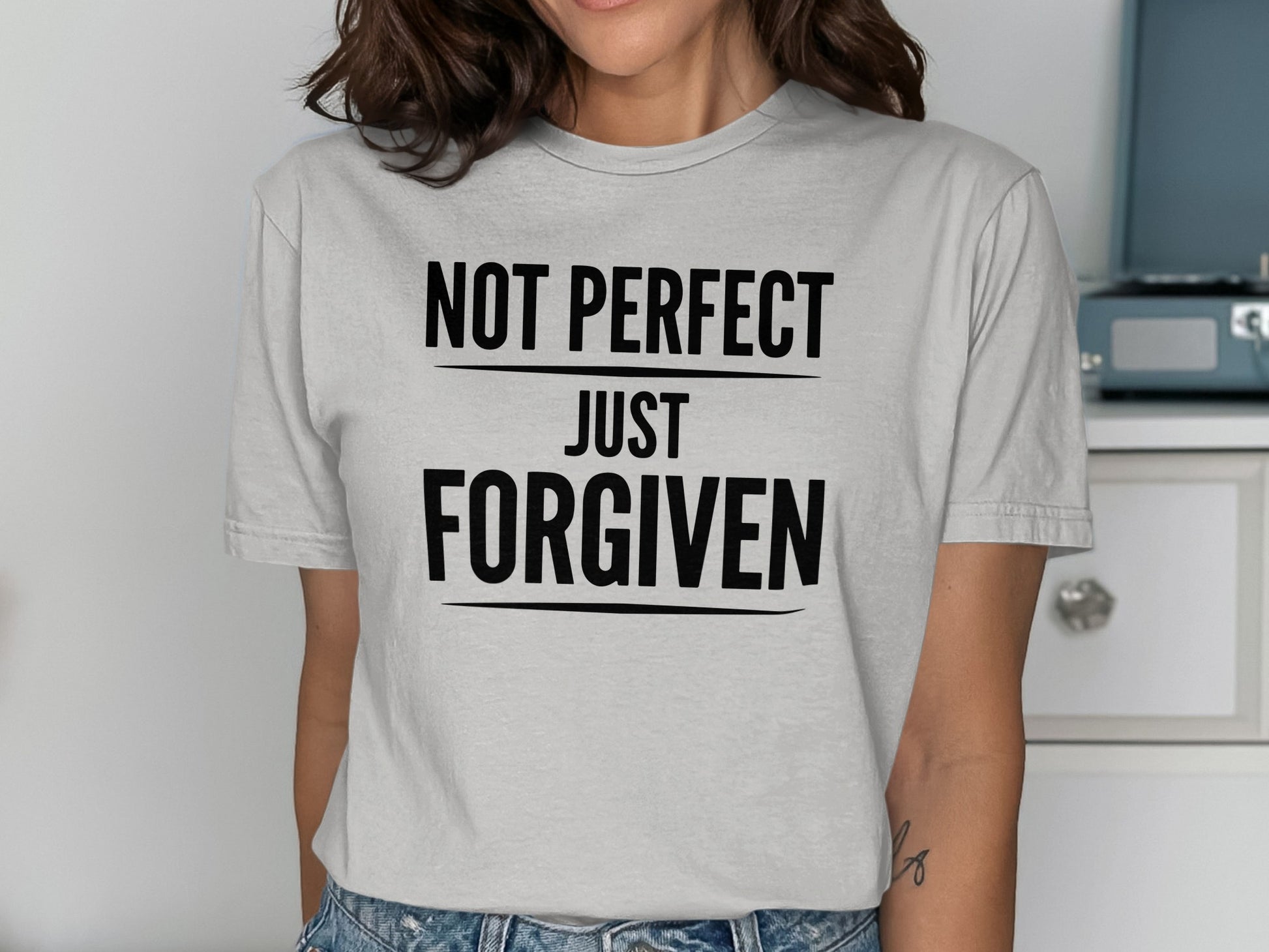 Light gray t-shirt with black text reading "NOT PERFECT JUST FORGIVEN".
