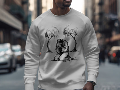 White crewneck sweatshirt with a black line drawing of a figure kneeling between two trees.