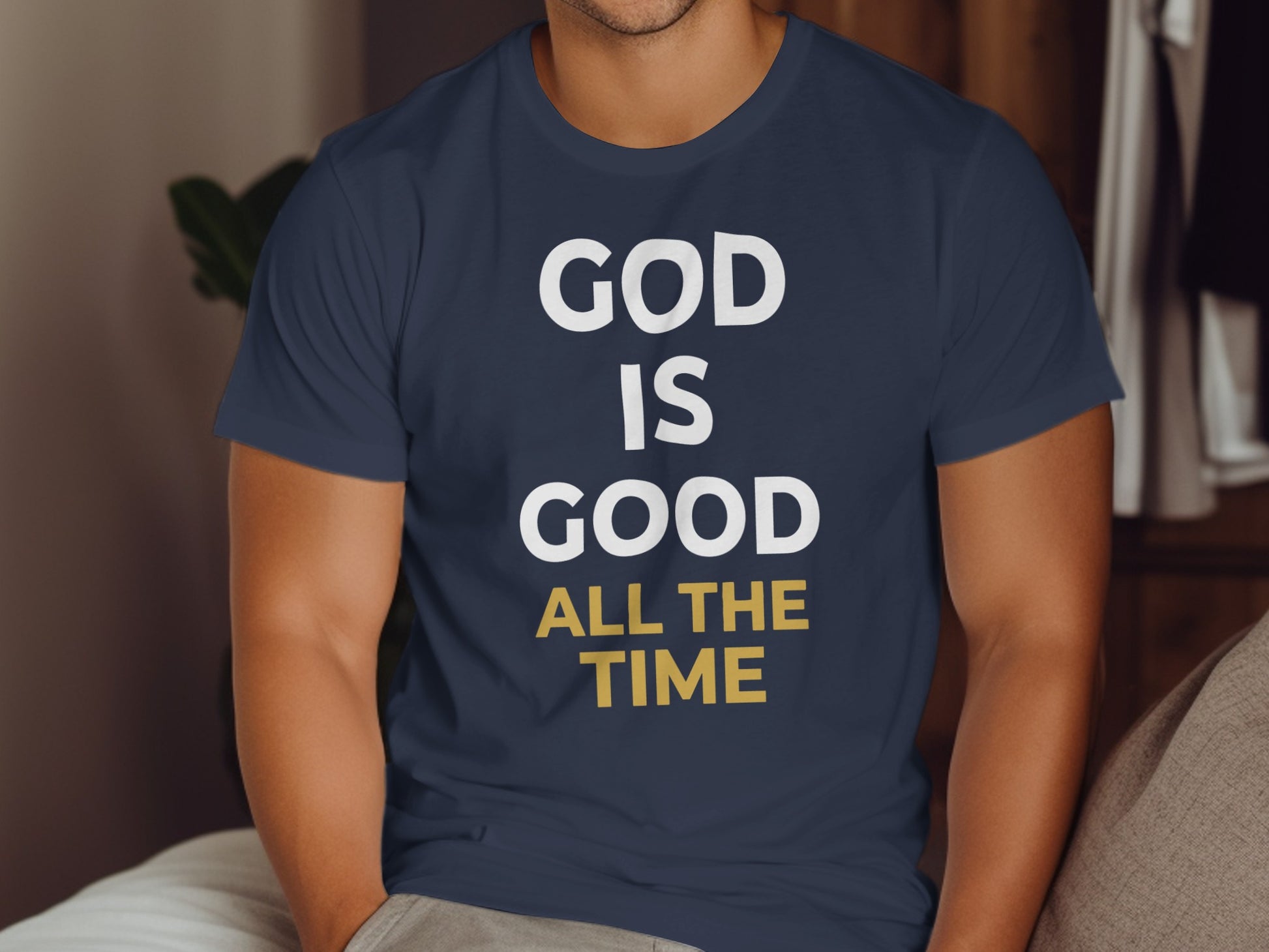 Dark blue t-shirt with white and yellow text "GOD IS GOOD ALL THE TIME".