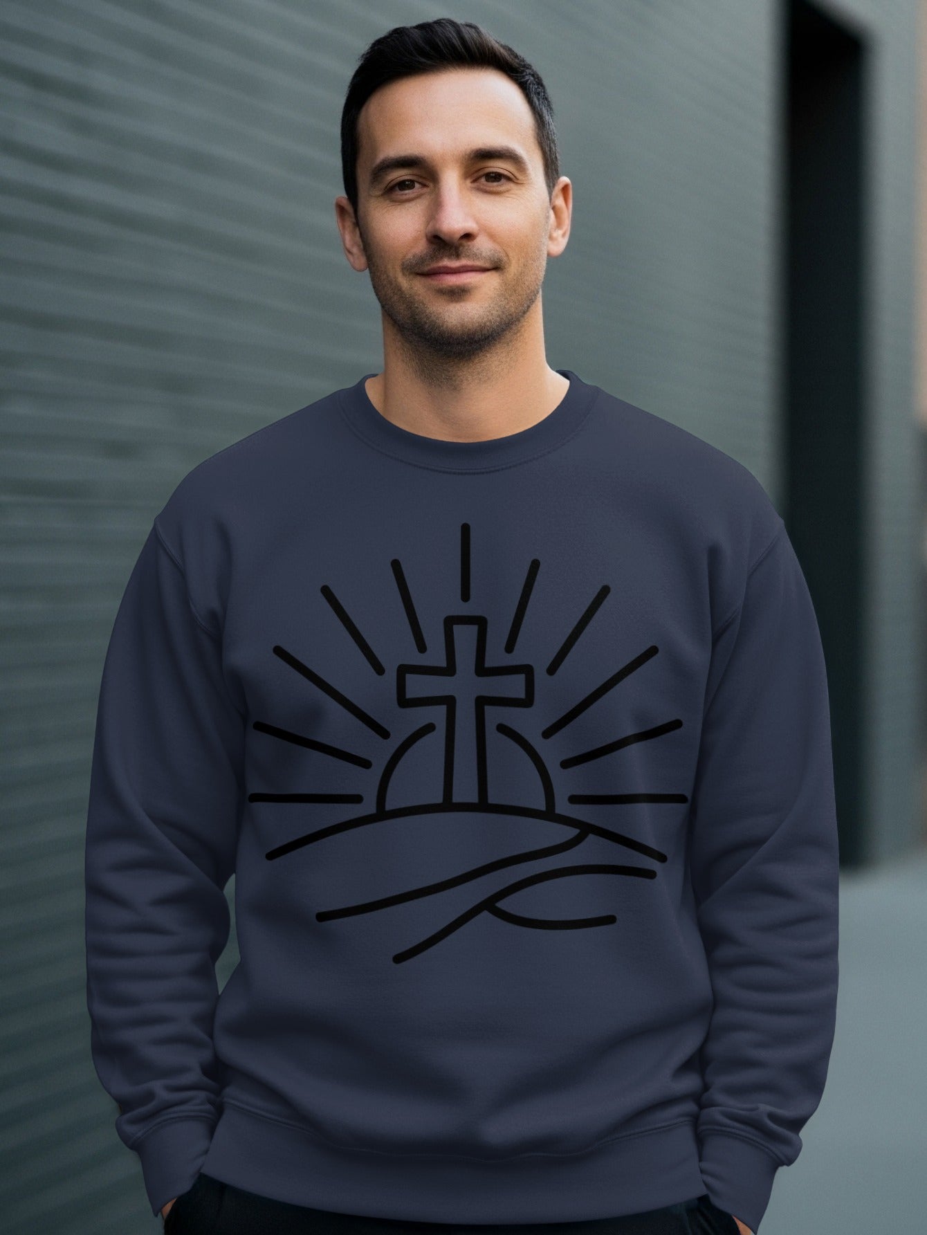 Navy sweatshirt with black outline of a cross on a hill with sun rays.