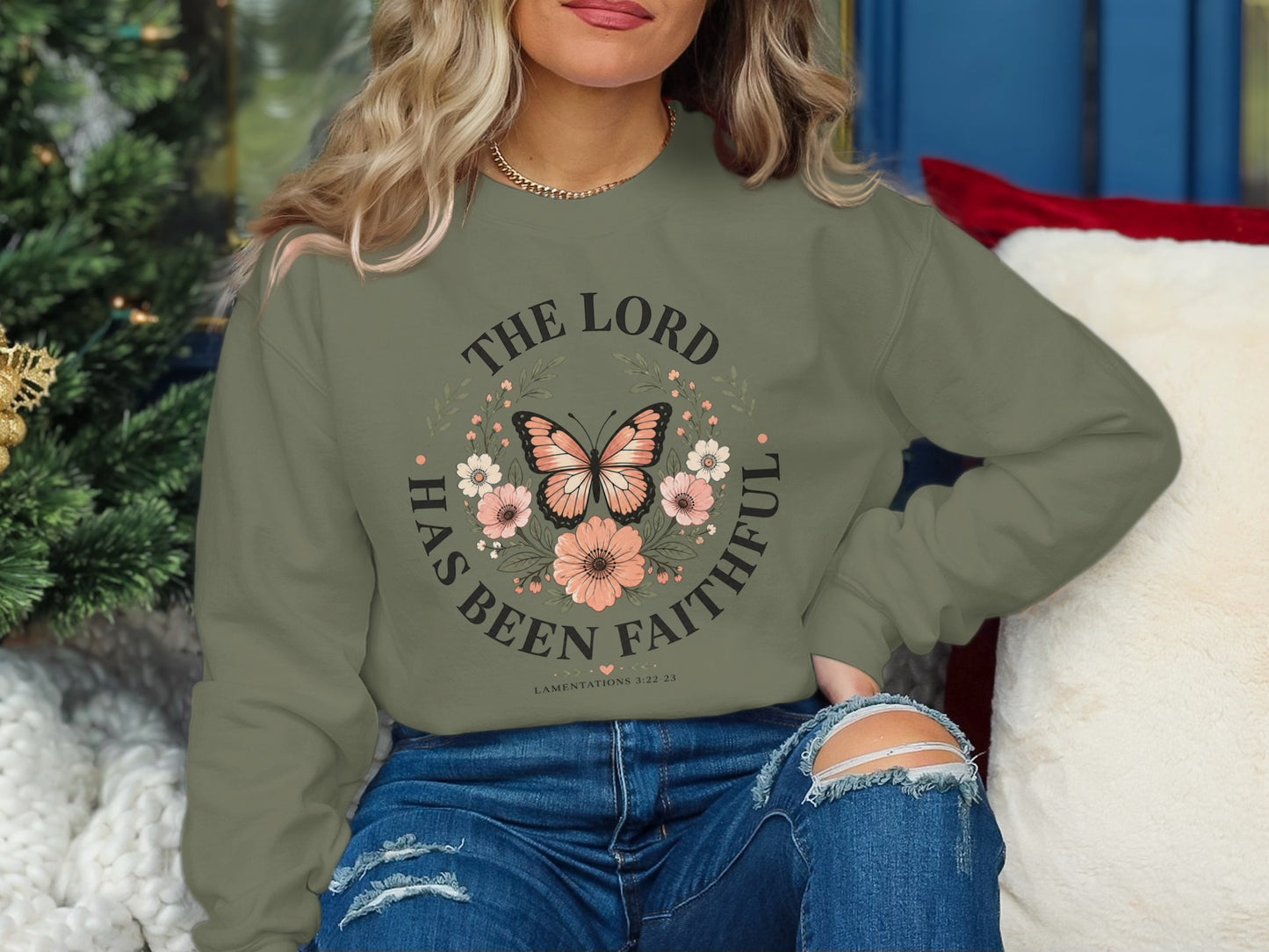 Olive green sweatshirt with "THE LORD HAS BEEN FAITHFUL" and butterfly graphic.