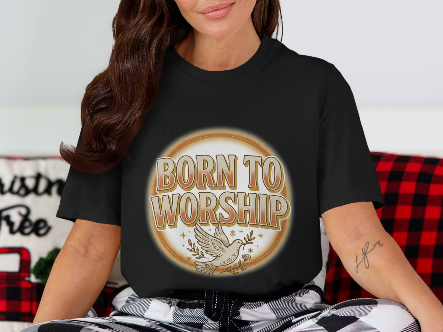 Black t-shirt with text "BORN TO WORSHIP" and a dove with an olive branch.