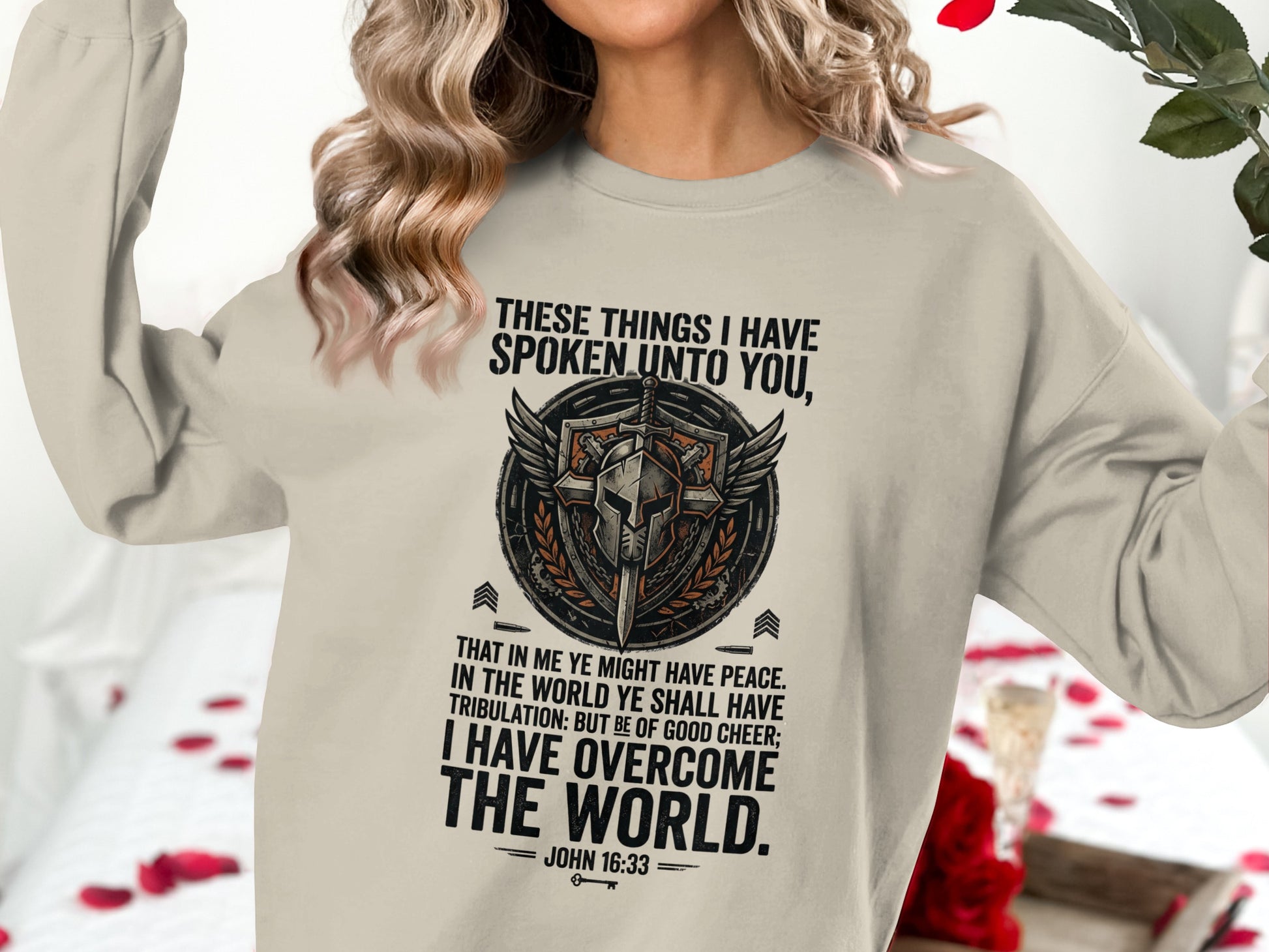 Sweatshirt with shield, wings, and Bible verse John 16:33.