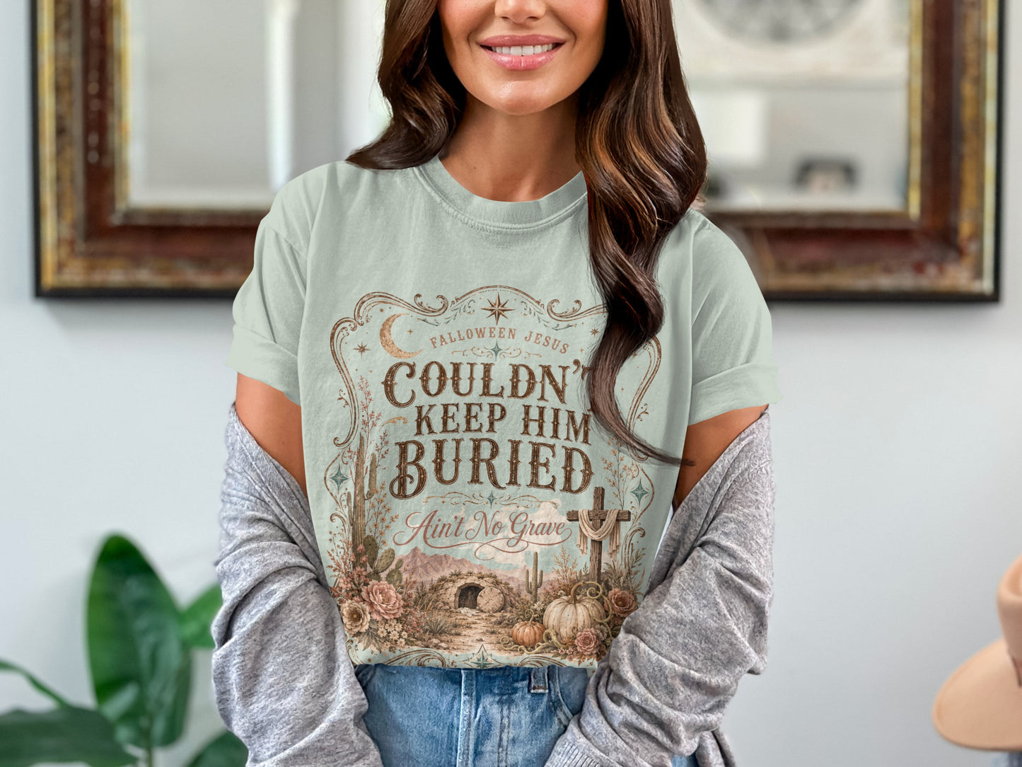 Light blue t-shirt with "Falloween Jesus Couldn't Keep Him Buried Ain't No Grave" graphic.