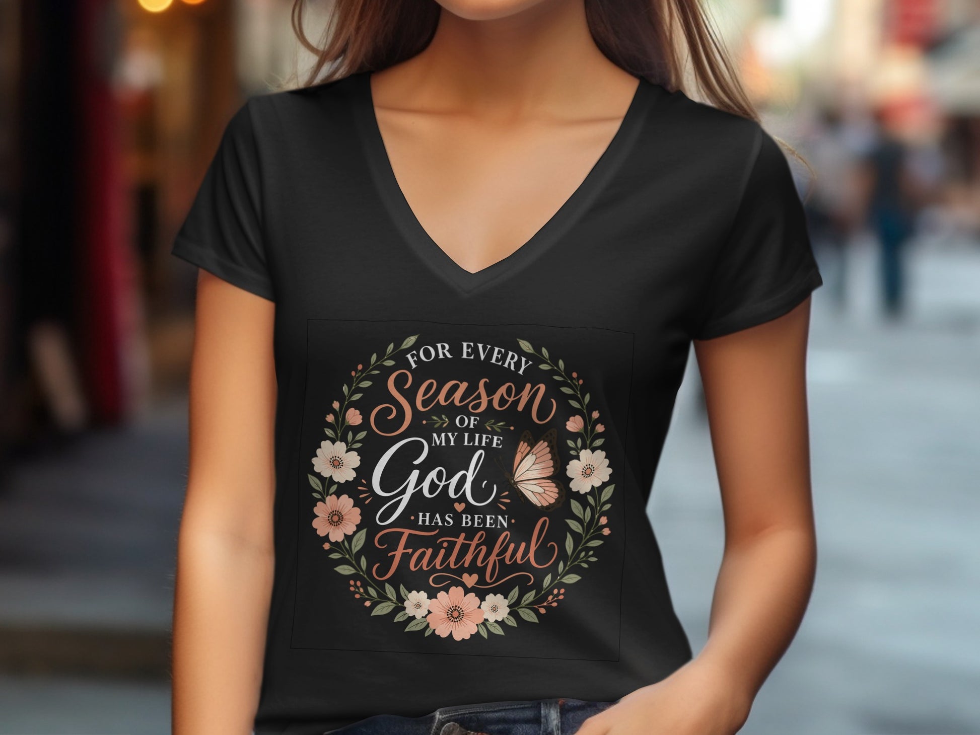 Black v-neck t-shirt with floral circle design and "God Has Been Faithful" text.