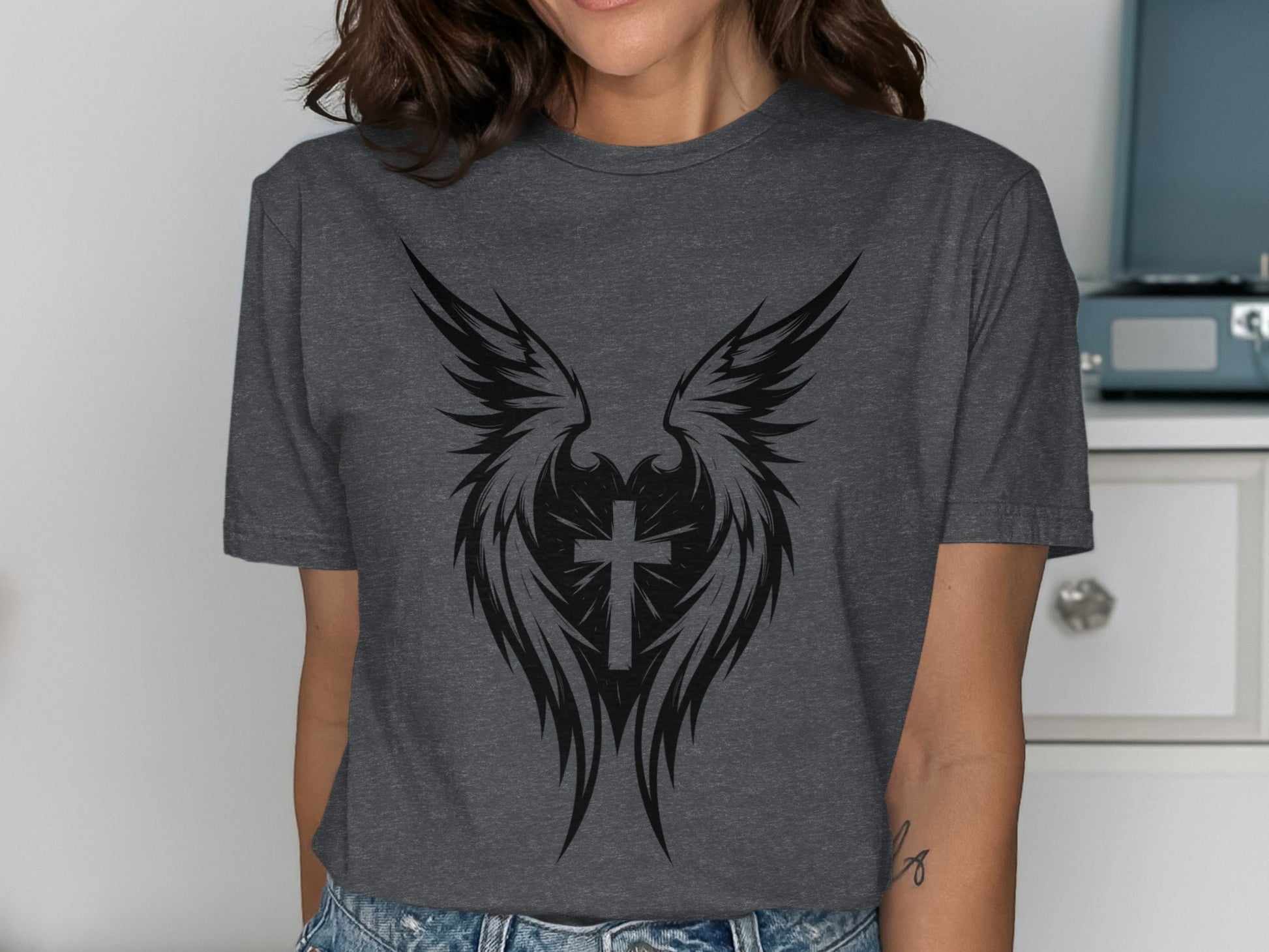 Dark gray t-shirt featuring a black winged cross heart graphic.
