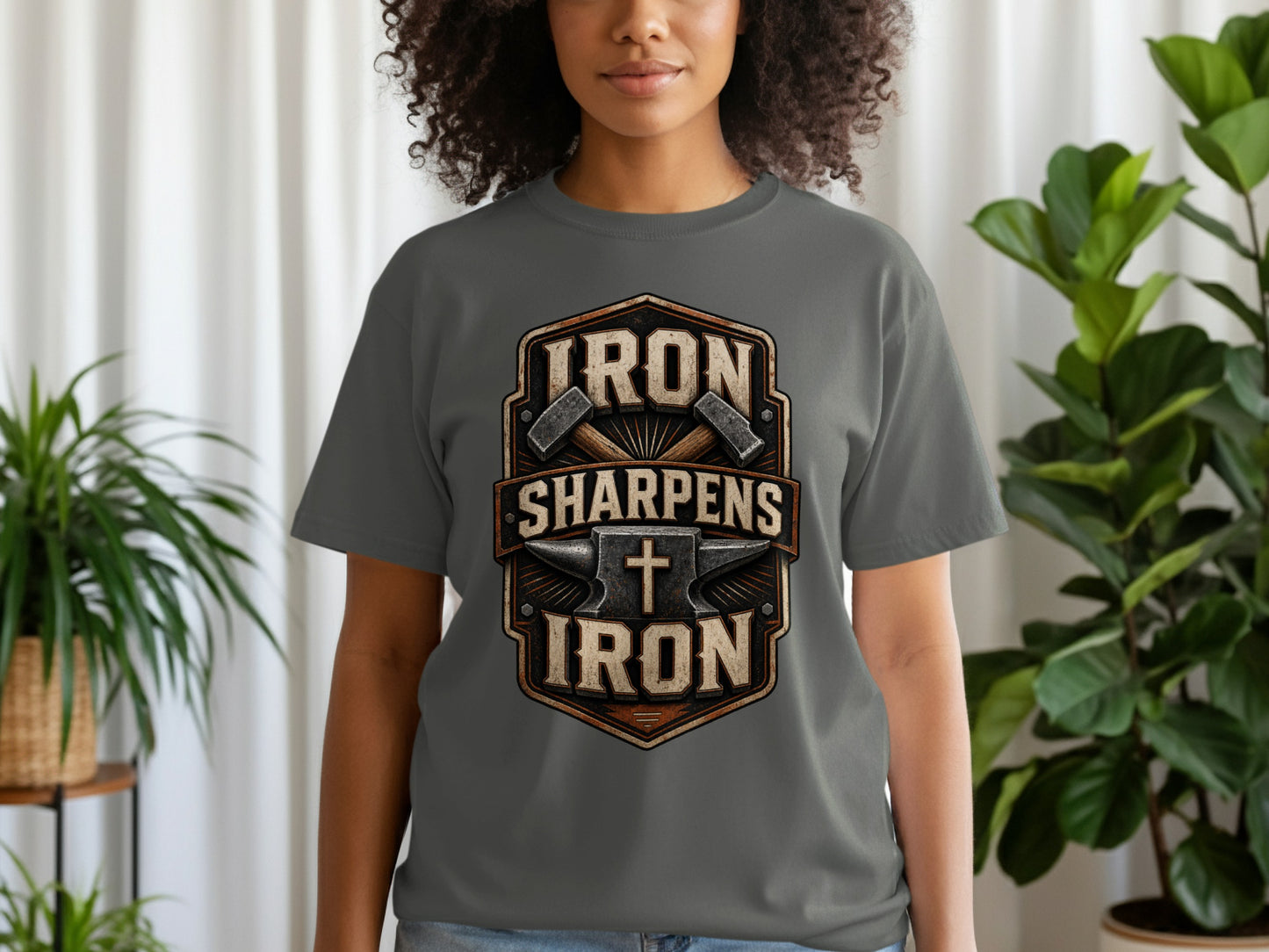 Dark grey t-shirt with "IRON SHARPENS IRON" text and anvil, hammers, and cross graphic.