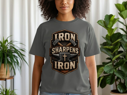 Dark grey t-shirt with "IRON SHARPENS IRON" text and anvil, hammers, and cross graphic.