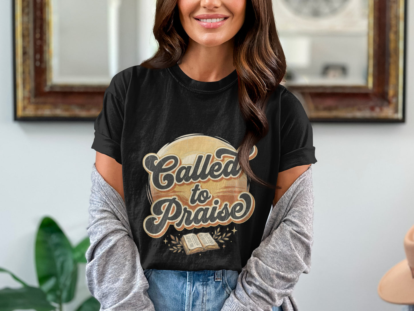 Black t-shirt graphic with text "Called to Praise" over an open book.