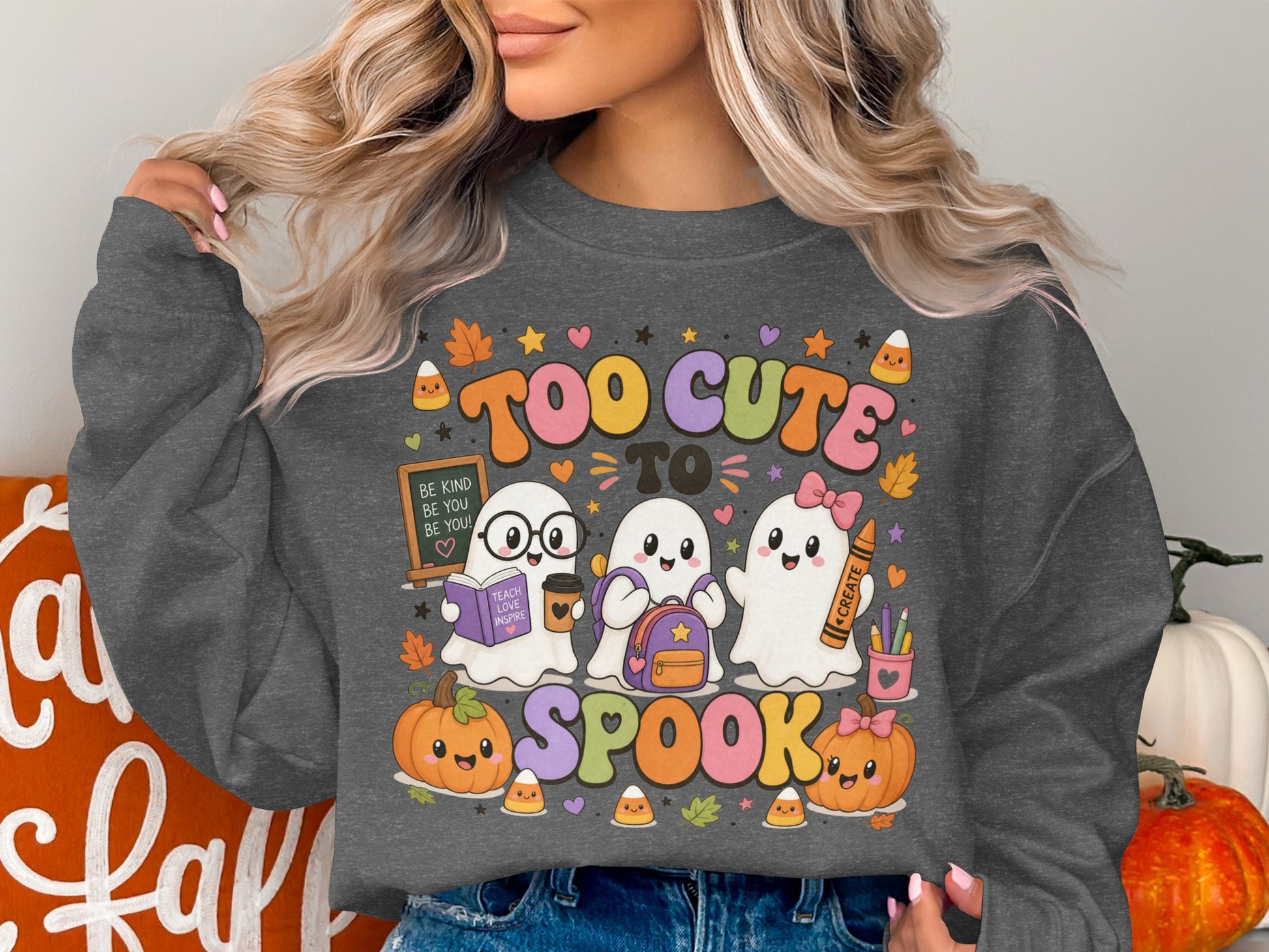 Three ghosts, pumpkins, and candy corn on a grey sweatshirt with the text "TOO CUTE TO SPOOK".