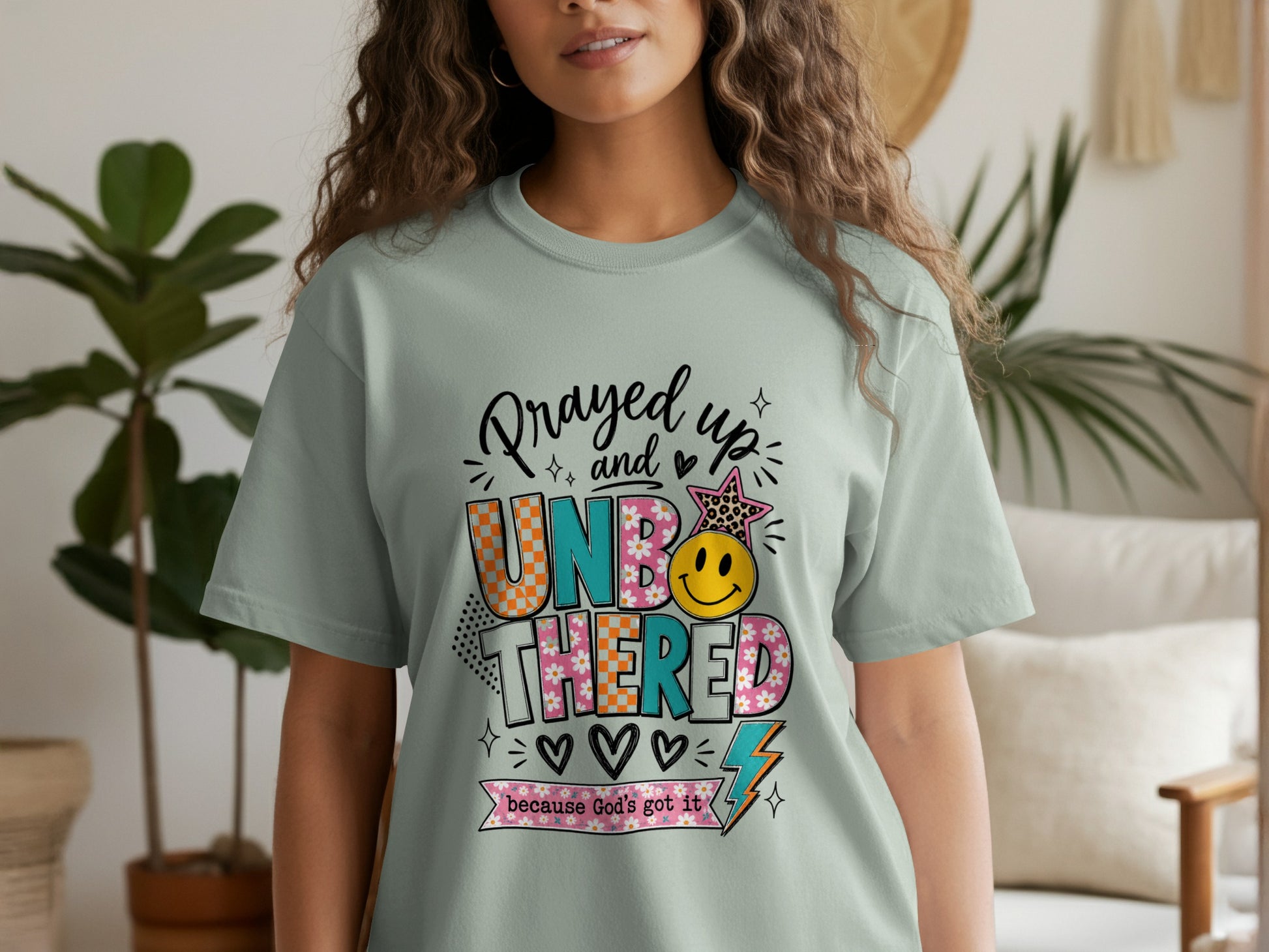 T-shirt with "Prayed up and UNBOTHERED because God's got it" text and graphics.