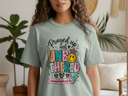 T-shirt with "Prayed up and UNBOTHERED because God's got it" text and graphics.