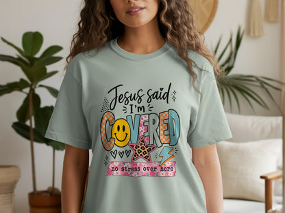 Light green t-shirt with "Jesus said I'm Covered no stress over here" graphic.