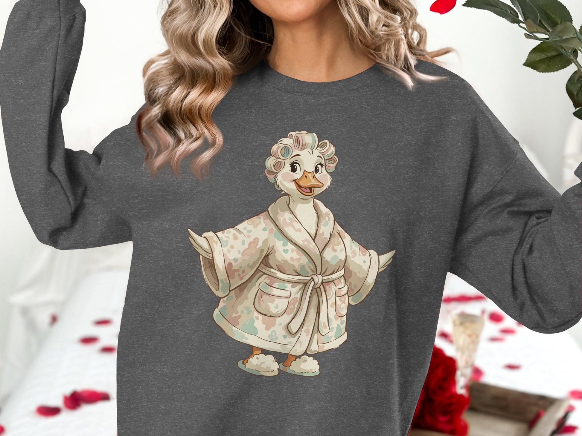 Duck character in a robe and curlers, wearing a grey sweatshirt.
