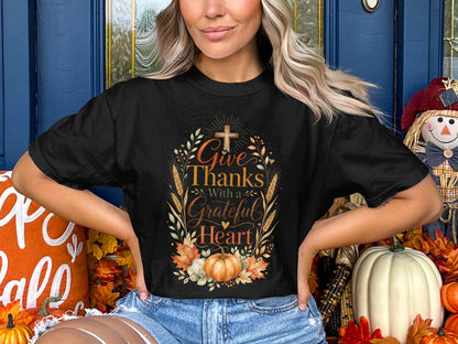 Black t-shirt with "Give Thanks With a Grateful Heart" text and floral pumpkin design.