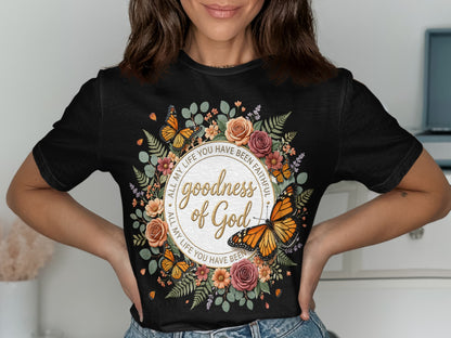 Black t-shirt with a floral wreath, butterflies, and "goodness of God" text.