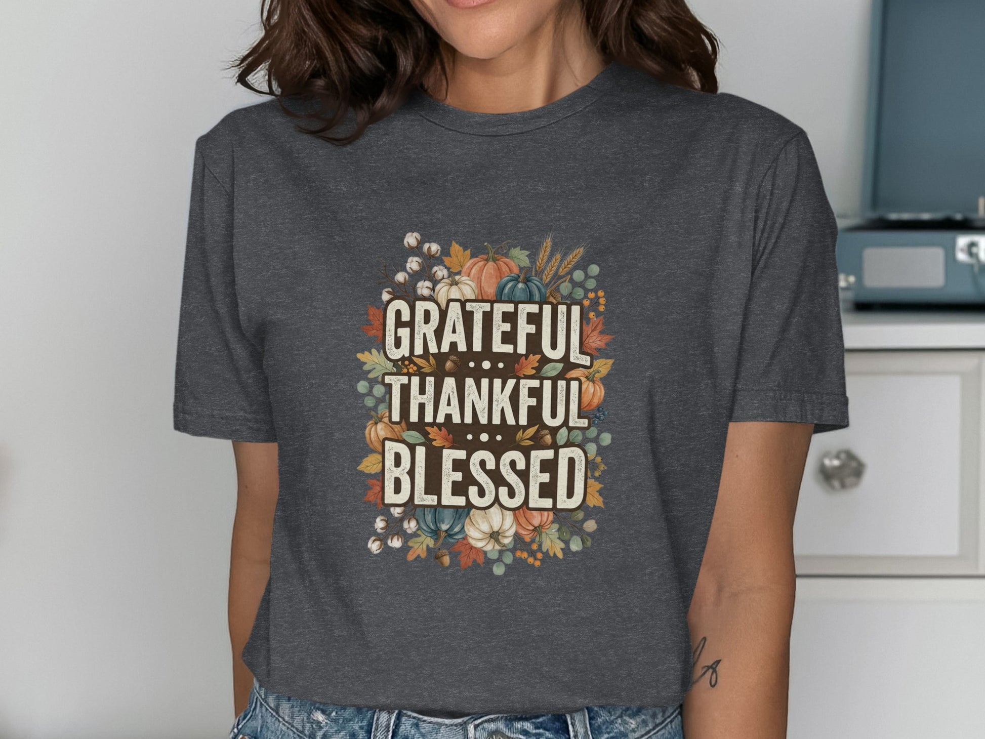 Dark t-shirt with "Grateful Thankful Blessed" text surrounded by autumn leaves and pumpkins.