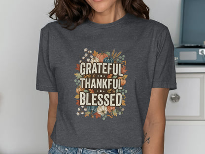 Dark t-shirt with "Grateful Thankful Blessed" text surrounded by autumn leaves and pumpkins.