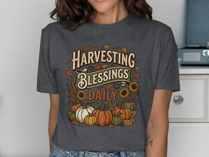 T-shirt with "Harvesting Blessings Daily" text and fall harvest graphic.