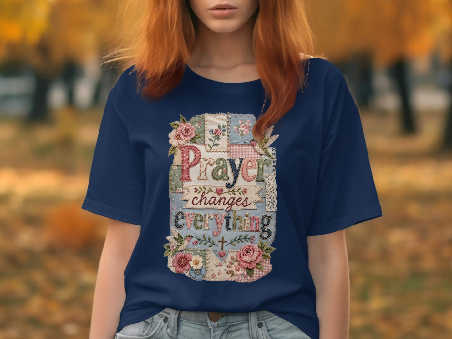 Navy t-shirt with "Prayer changes everything" text and floral patchwork design.