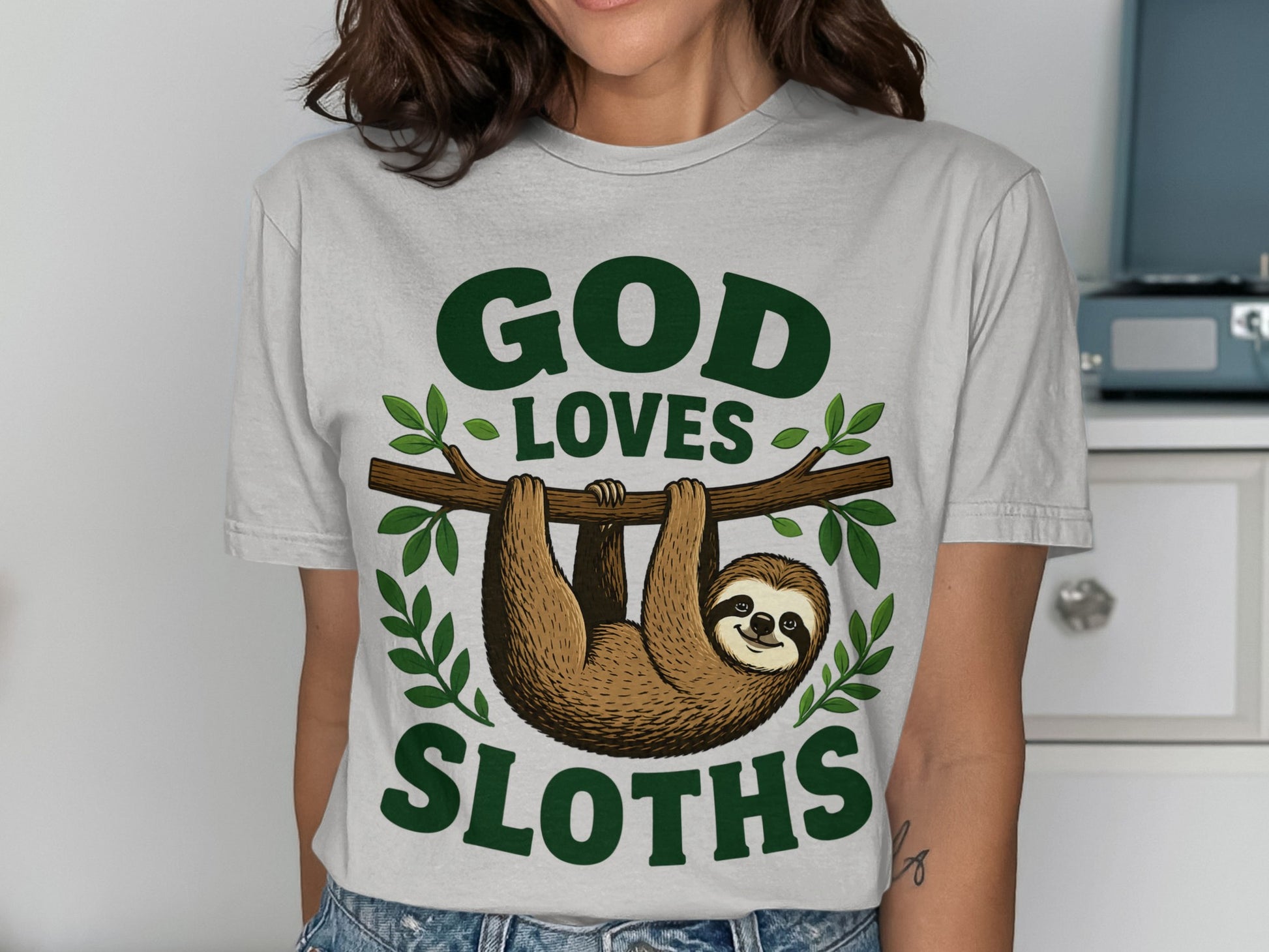 T-shirt with "God Loves Sloths" text and a sloth hanging on a branch.