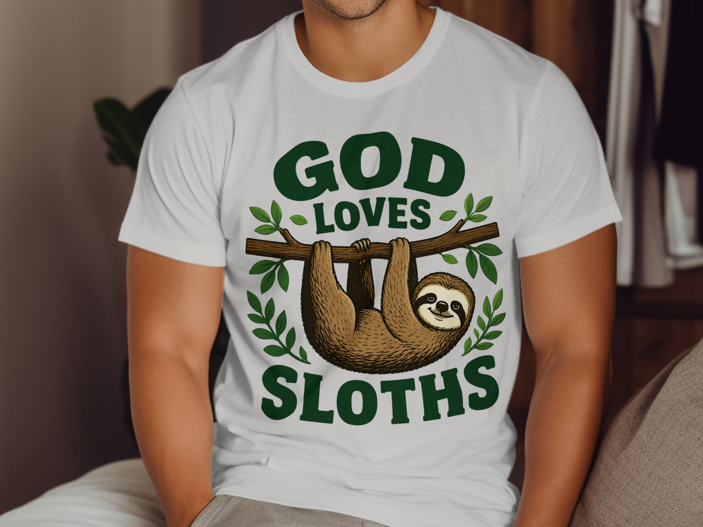 White t-shirt with "God Loves Sloths" text and a sloth hanging from a branch.