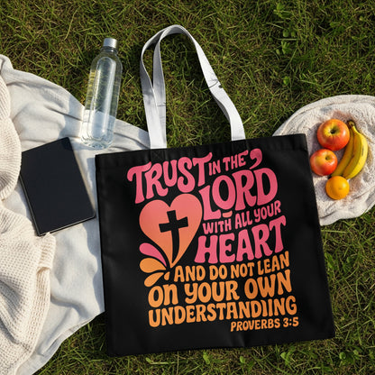 Black tote bag with "Trust in the Lord" text and a heart with a cross.
