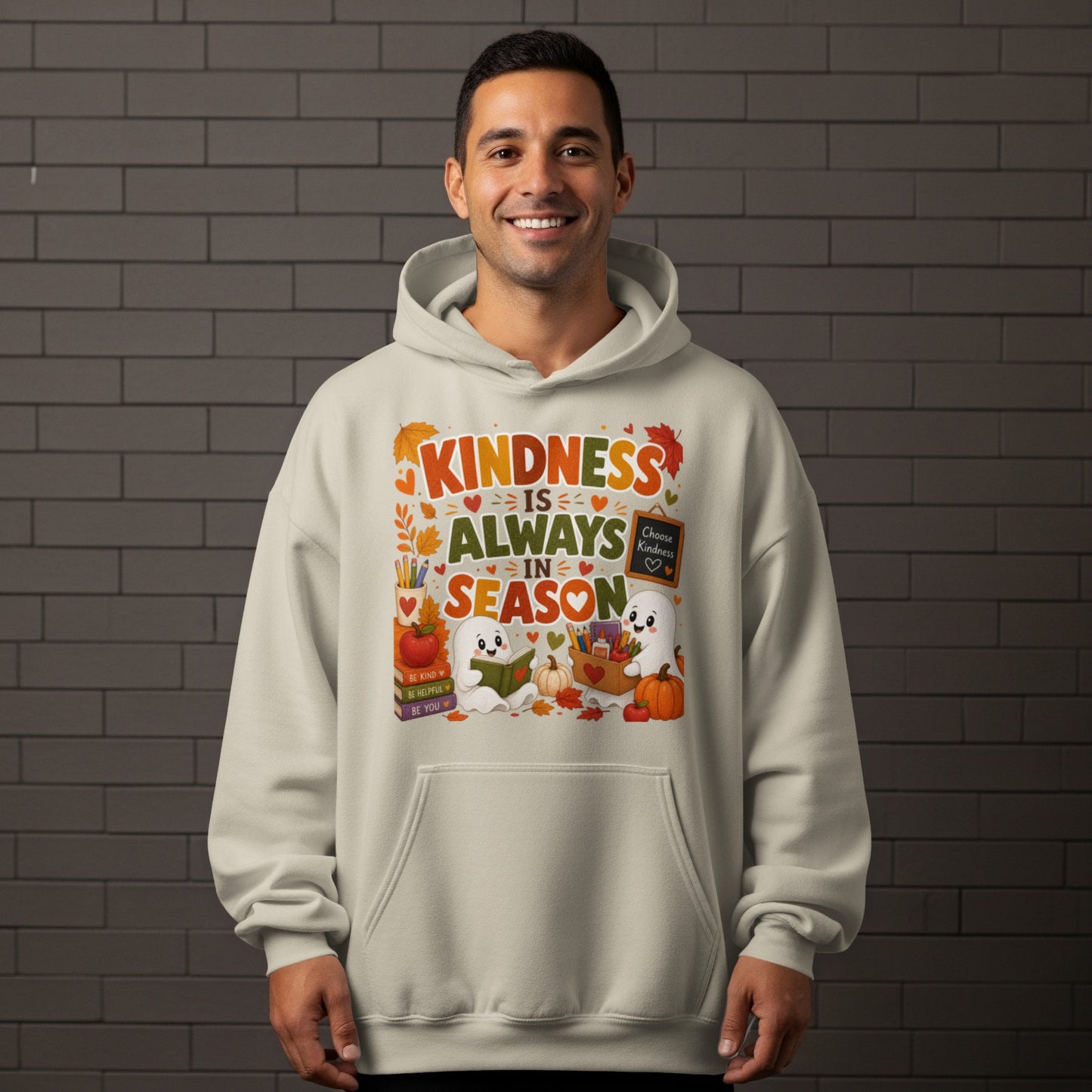 Light beige hoodie with "Kindness is Always in Season" graphic featuring ghosts, pumpkins, and books.