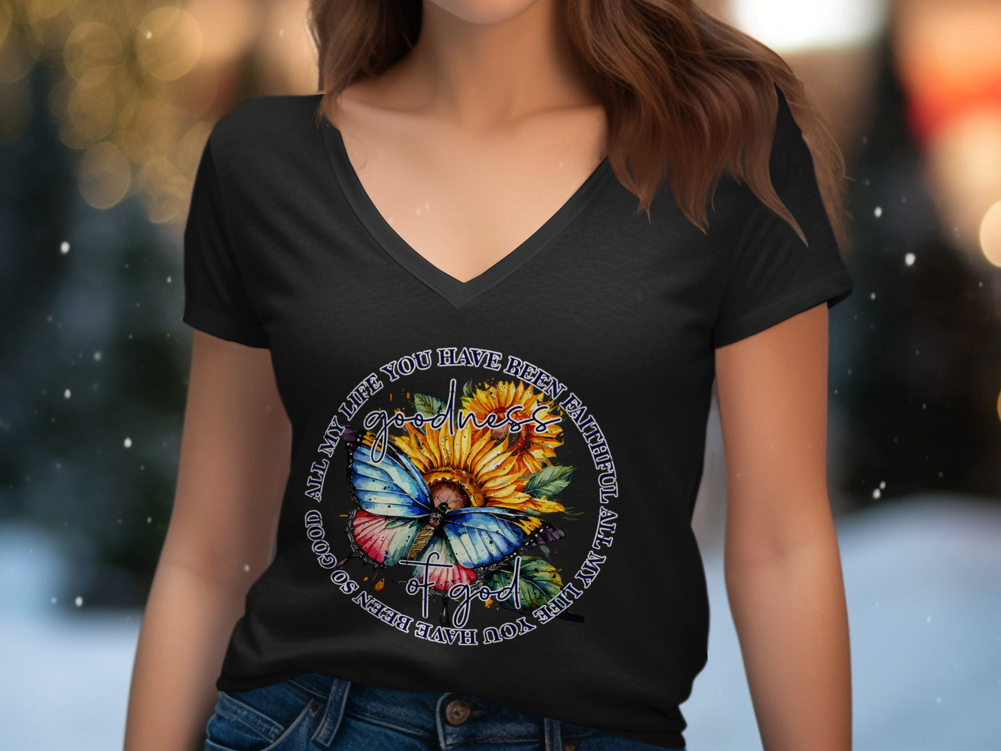 Black v-neck t-shirt with butterfly and sunflower graphic, "Goodness of God" text.