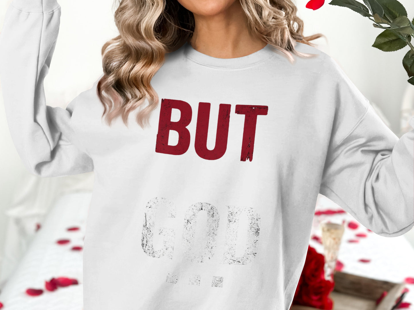 White sweatshirt with red text "BUT GOD".