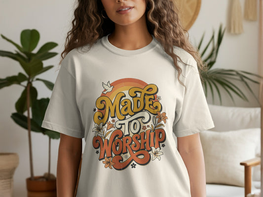 Cream t-shirt with "Made To Worship" text, flowers, a dove, and retro rainbow graphic.