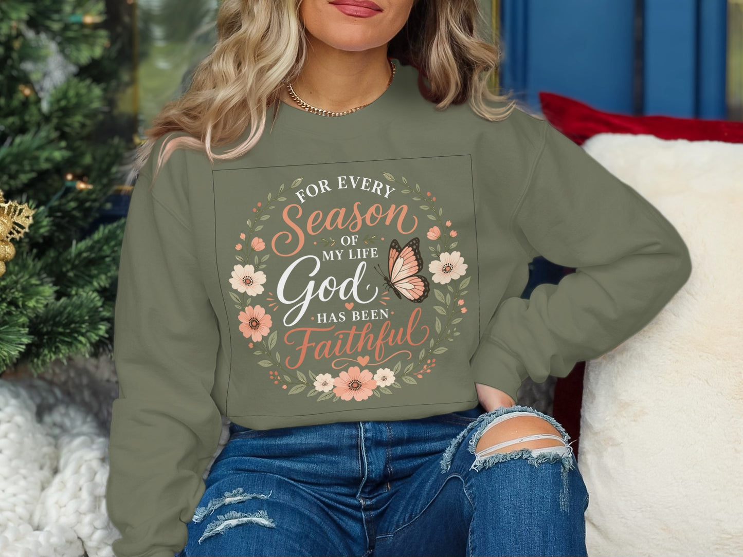 Olive green sweatshirt with floral wreath and "For every season of my life God has been faithful" text.