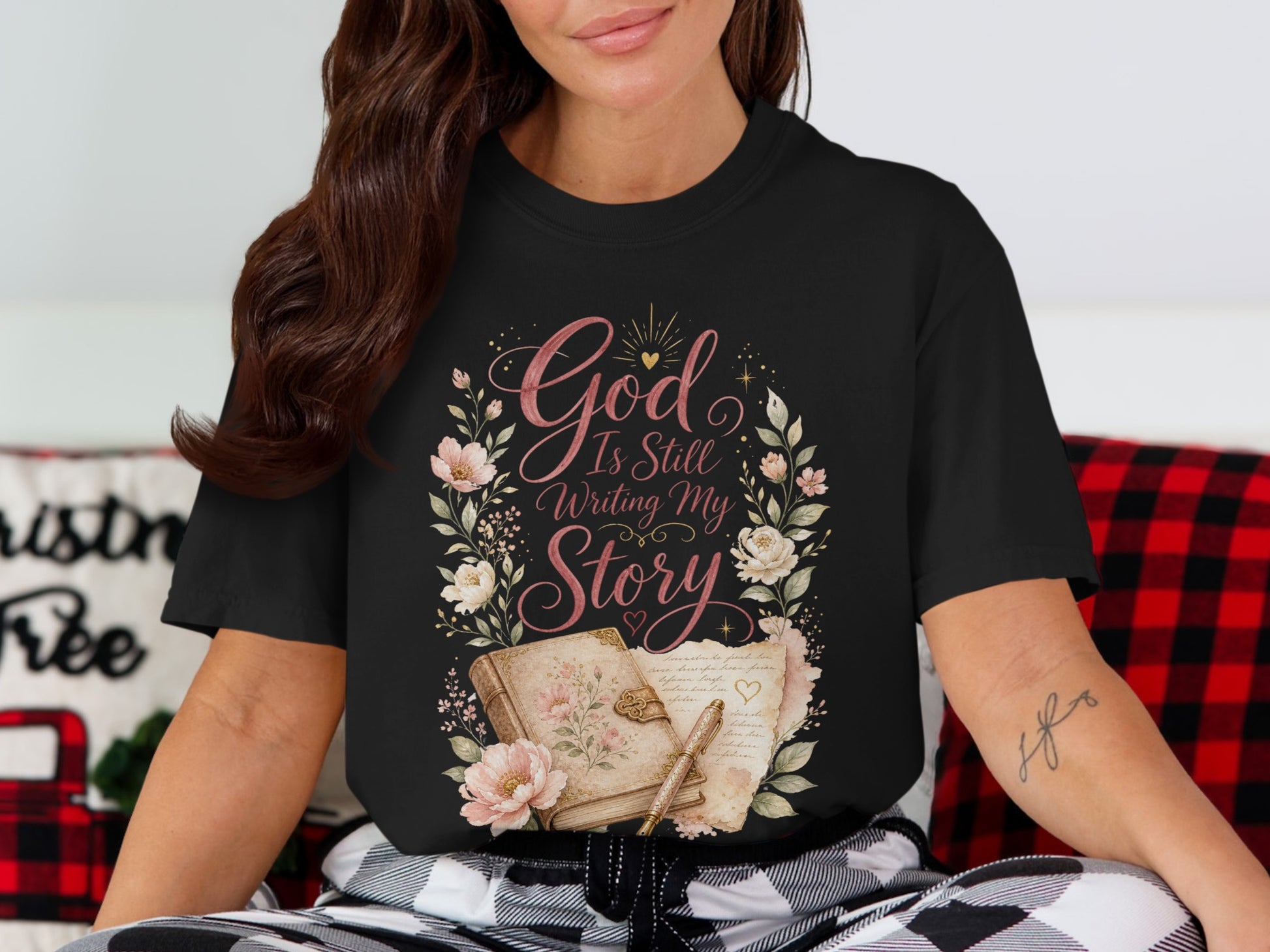 Black t-shirt with floral design and text "God Is Still Writing My Story".