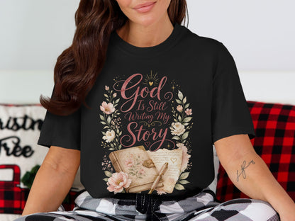 Black t-shirt with floral design and text "God Is Still Writing My Story".