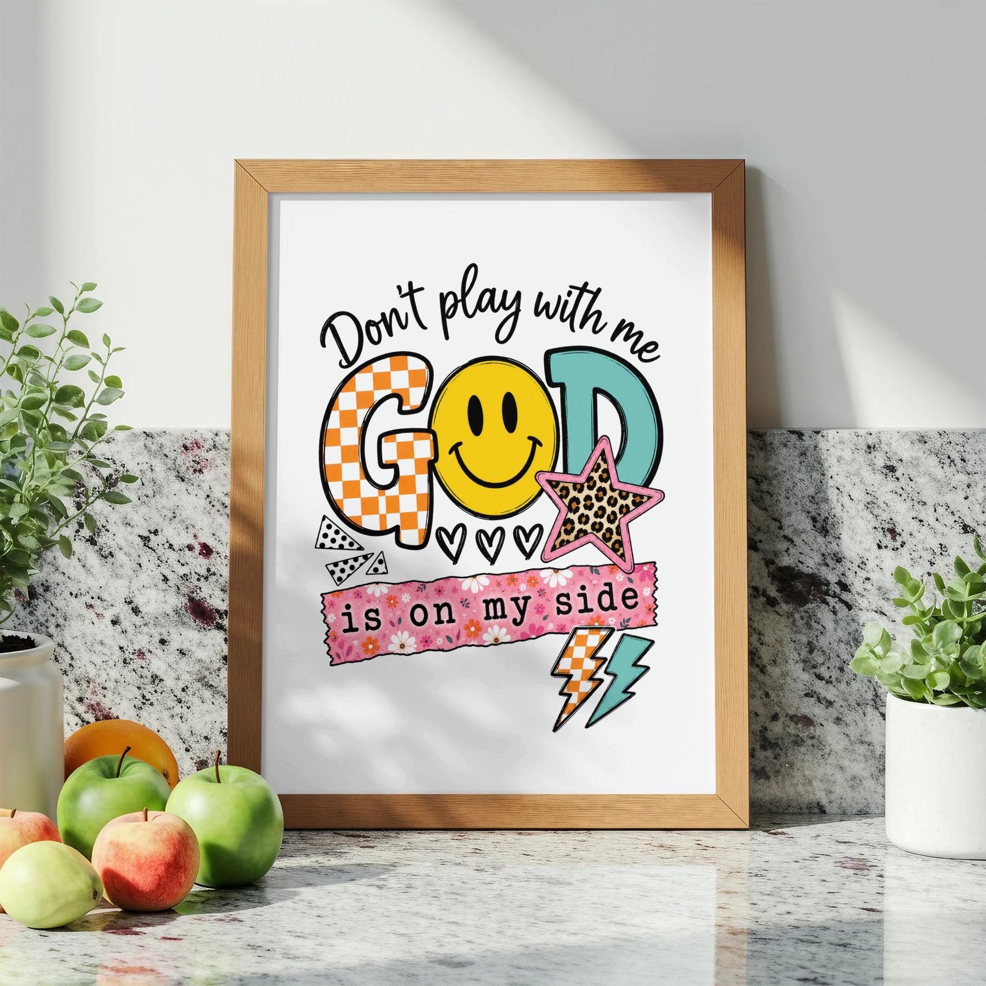 Framed art with text "Don't play with me GOD is on my side" and graphics.