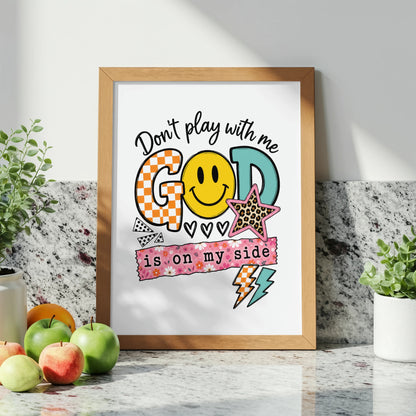 Framed art with text "Don't play with me GOD is on my side" and graphics.