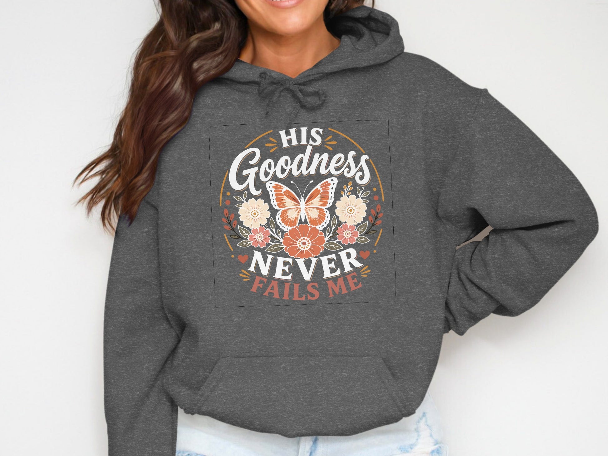 Dark gray hoodie with "His Goodness Never Fails Me" text and butterfly design.