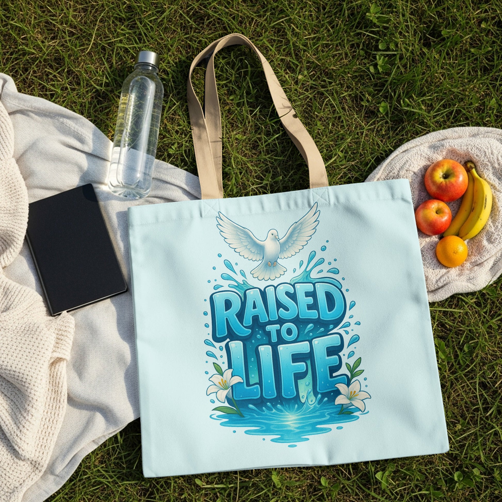 Light blue tote bag with white dove and "RAISED TO LIFE" text design.