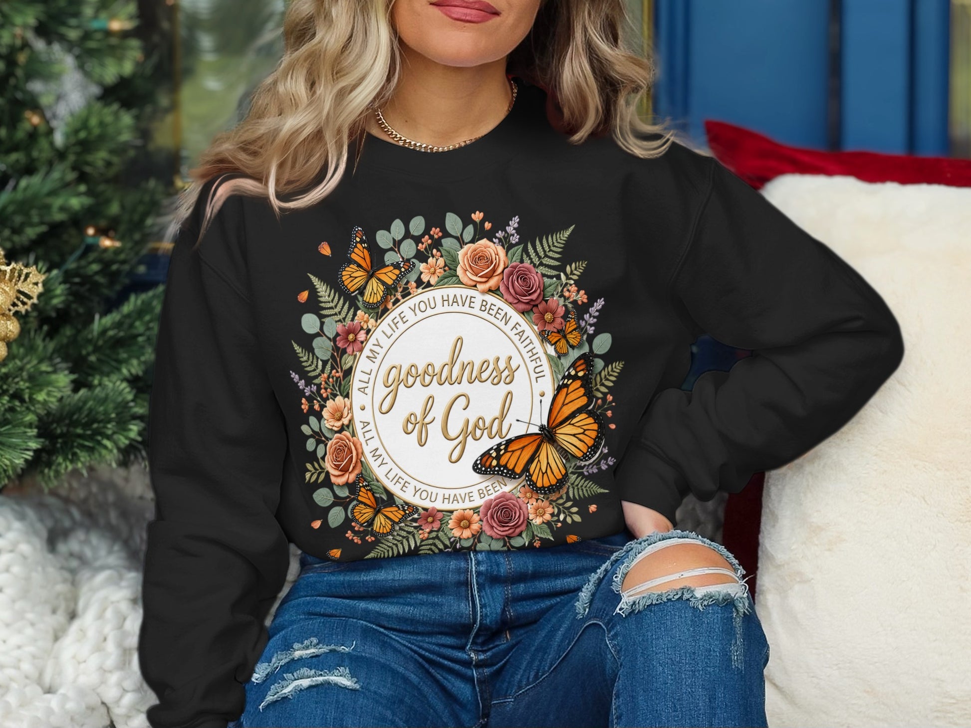 Black sweatshirt with "Godness of Gold" and butterflies floral wreath design.