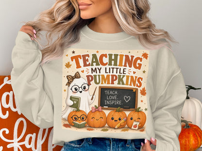 Ghost teacher with pumpkins wearing glasses, holding book, with text "Teaching My Little Pumpkins".