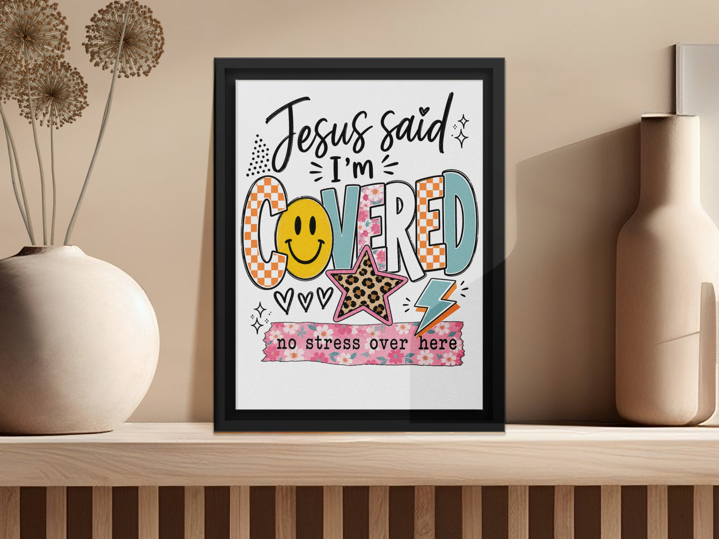 Framed art with "Jesus said I'm COVERED" and "no stress over here" text.