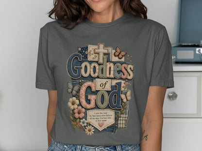 T-shirt with "Goodness of God" text, butterflies, and flowers design.