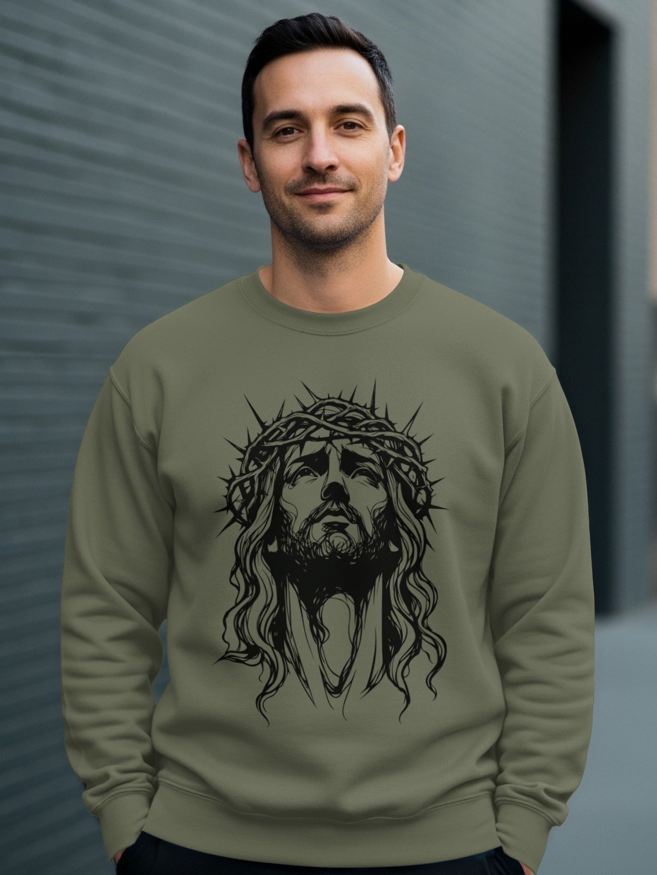 Man wearing a dark green crewneck sweatshirt with Jesus Christ graphic.