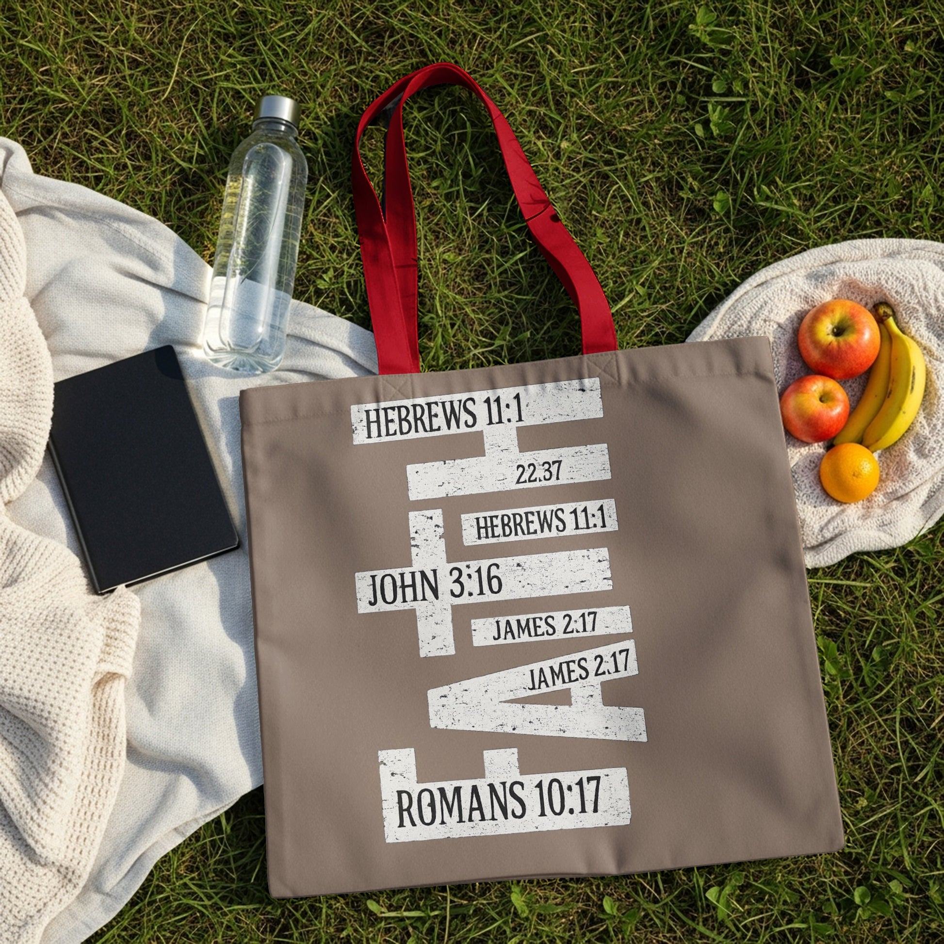Tote bag with Bible verses in white text on a taupe background.
