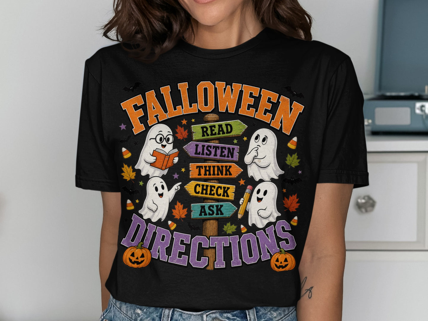 Black t-shirt with "Falloween Directions" and ghosts reading, listening, thinking, checking, and asking.