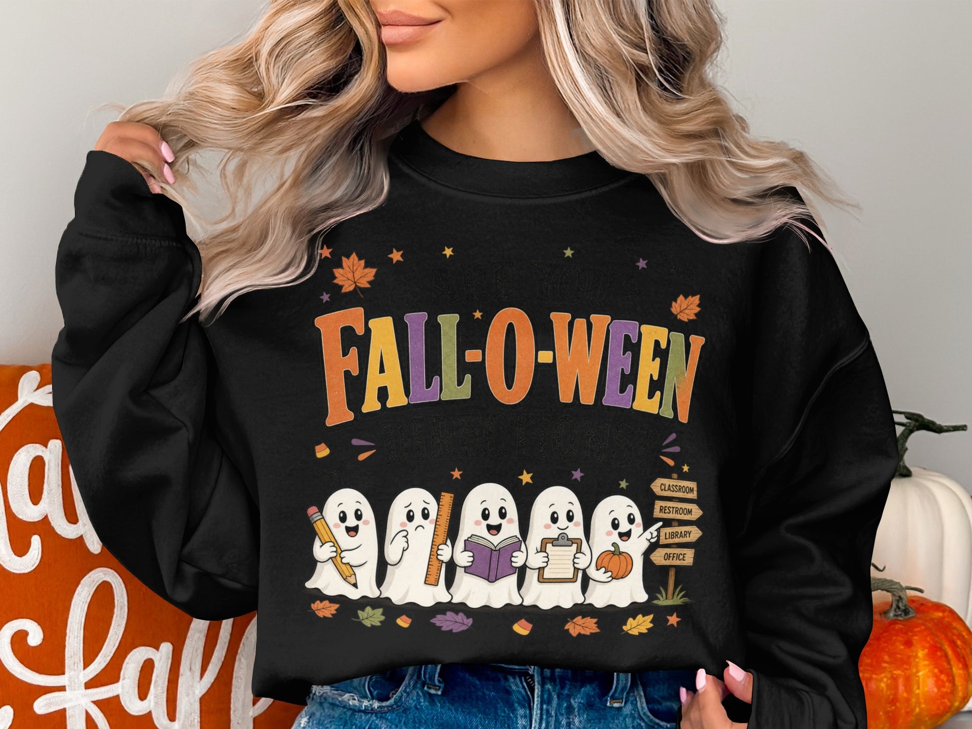 Black sweatshirt with "Fall-o-ween" text and ghosts holding school supplies and a pumpkin.