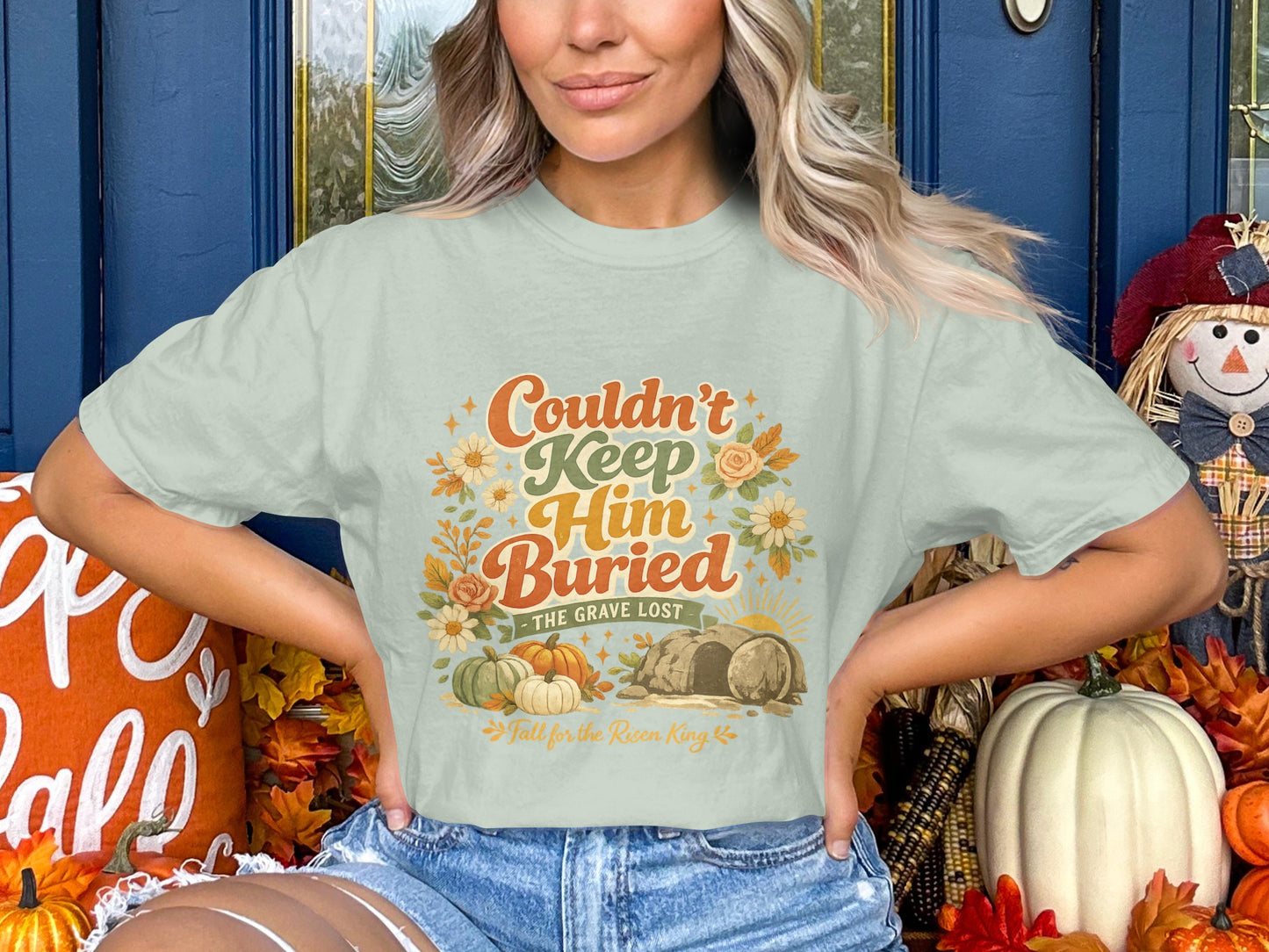 Light green t-shirt with "Couldn't Keep Him Buried - The Grave Lost" graphic.